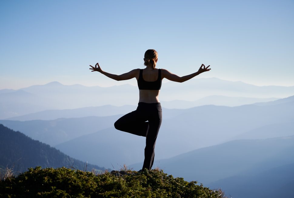 lady-doing-yoga-at-the-top-of-hill