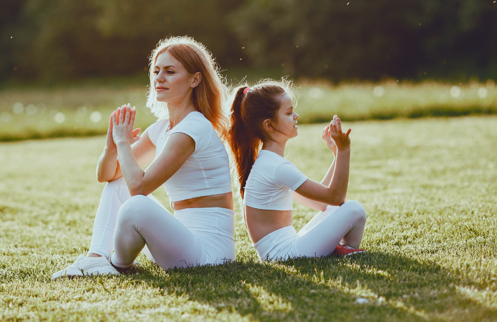 mom and daughter doing a family yoga gaining the bonding experience