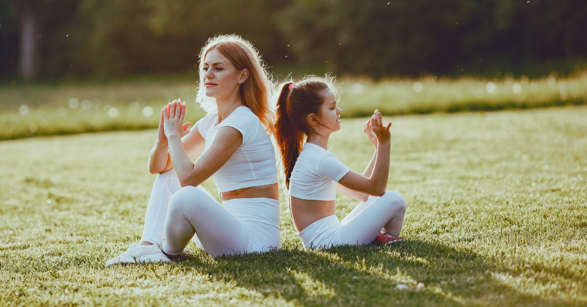 mom and daughter doing a family yoga gaining the bonding experience