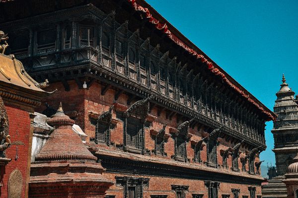 This is 55 windows picture under the blue sky  and aside it there is small temples