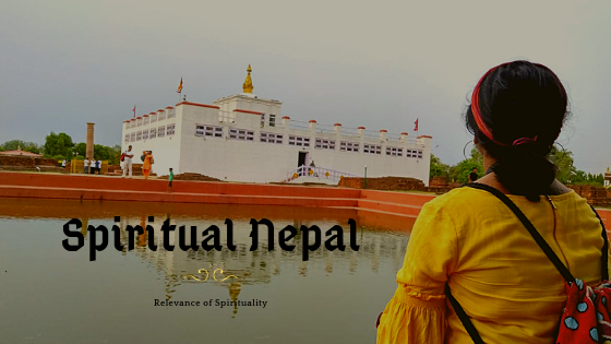 Lumbini, the birthplace of Buddha, features a serene pond with a girl praying while gazing at the Lumbini Temple.