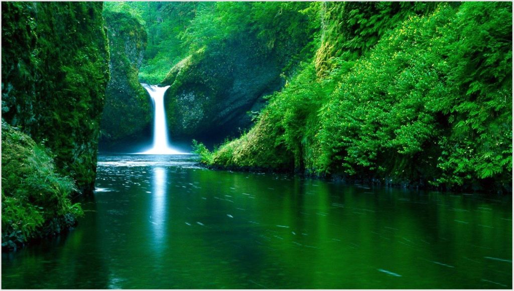 The image shows a beautiful waterfall surrounded by lush green trees. The waterfall flows into a calm, clear pool of water. The rocks around the waterfall are covered in moss and ferns. The sunlight filters through the trees and casts dappled shadows on the water. The overall atmosphere is peaceful and serene.




The image shows a beautiful town nestled in a valley surrounded by mountains. The town is made up of many small, red-brick houses with tiled roofs. There are also a few temples and other buildings that stand out. The mountains are covered in green vegetation, and the sky is blue with white clouds. The overall atmosphere of the image is peaceful and serene.



