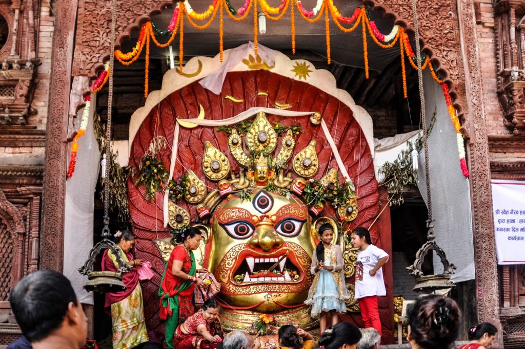 the pictuer is of "Swet Bhairab" where different small children on the right side and other female ladies are worshipping. the statue is under the wooden craft as well