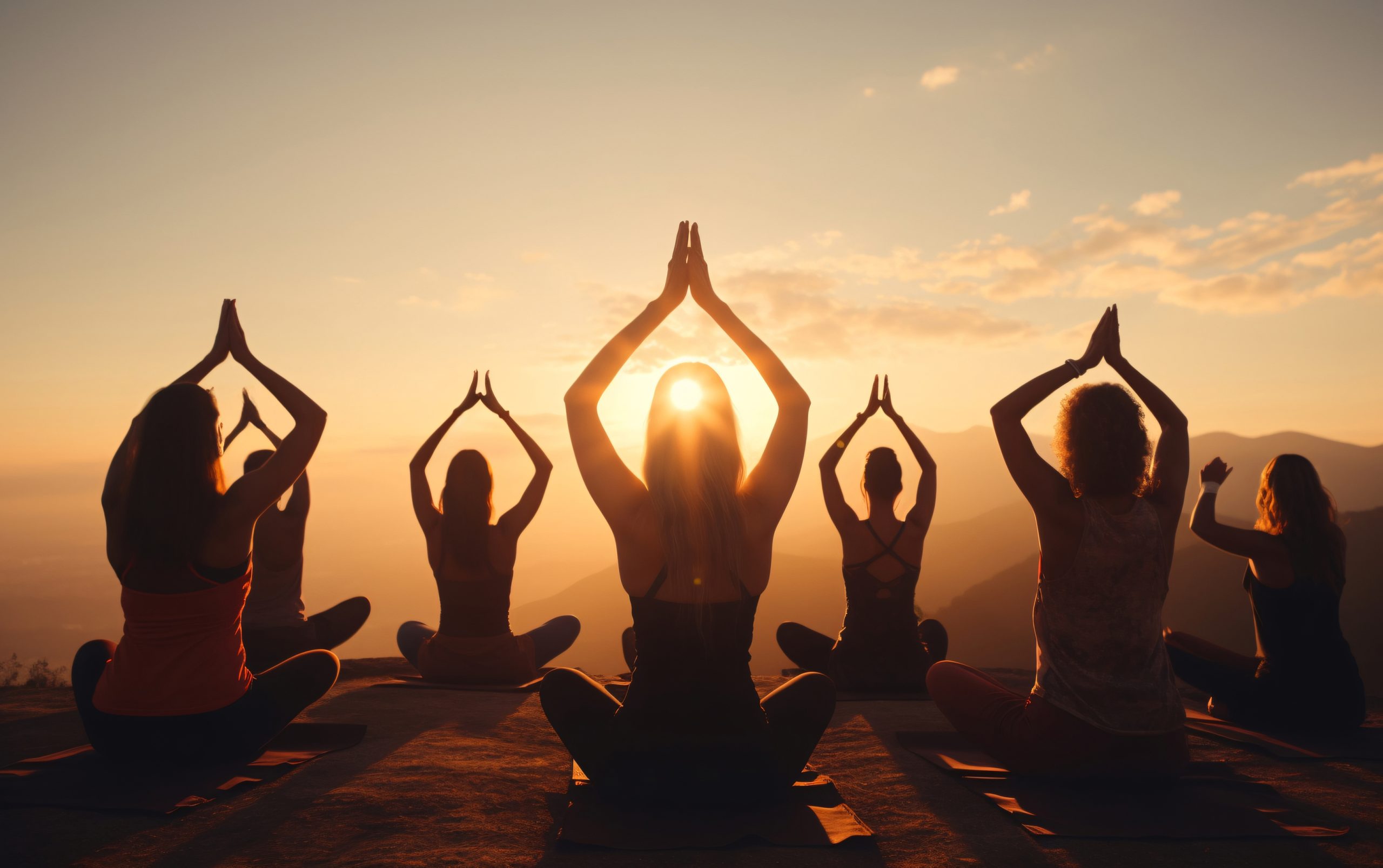 The image shows a yoga session taking place in the early morning light, with the sun just starting to rise.