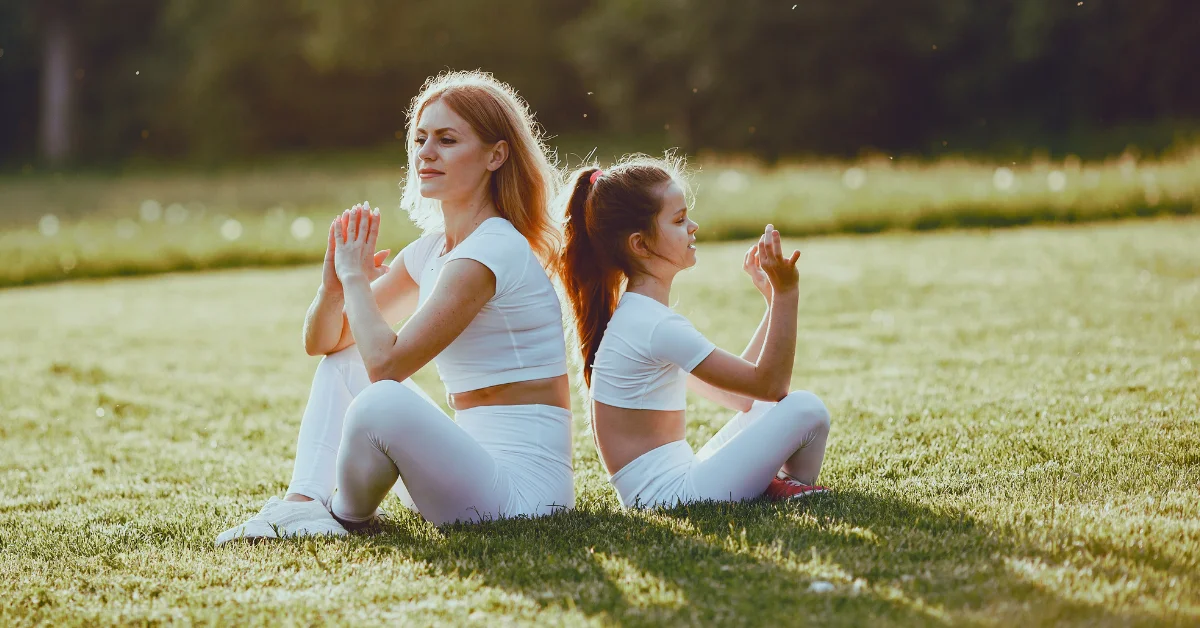 mom and daughter doing a family yoga gaining the bonding experience
